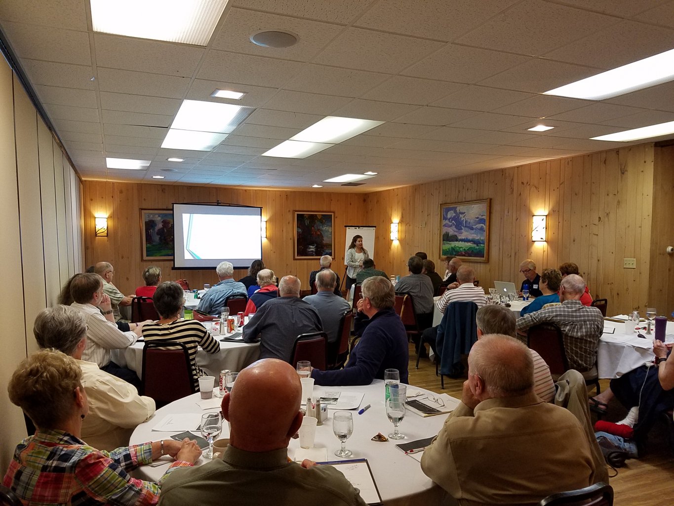 Participants view a presentation at a workshop